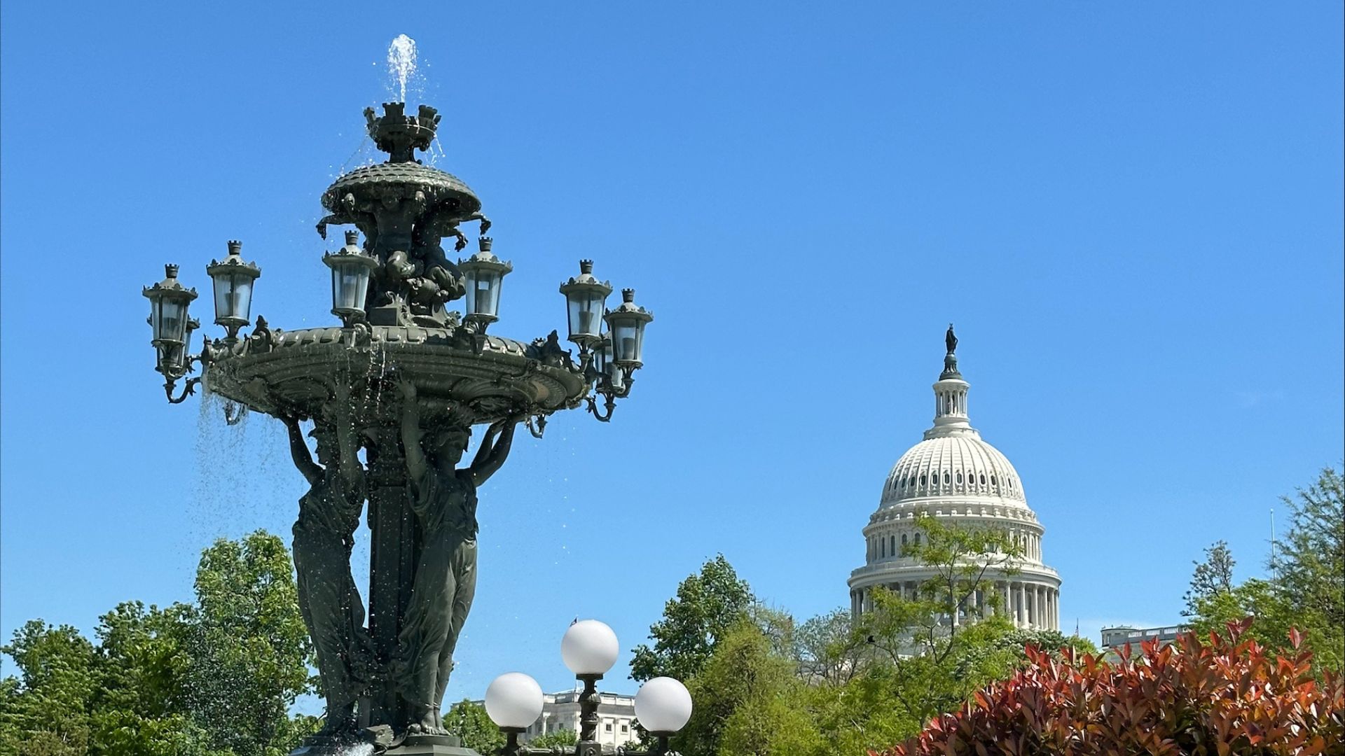 The Bartholdi fountain sprays water with the U.S. Capitol dome in the distance